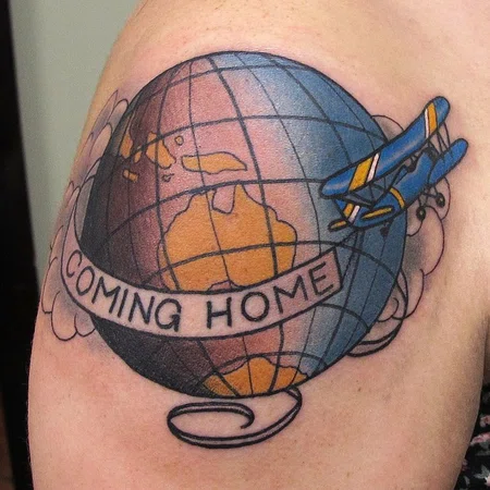 Globe tattoo with writing on shoulder for men