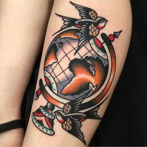 Globe tattoo on shin for women