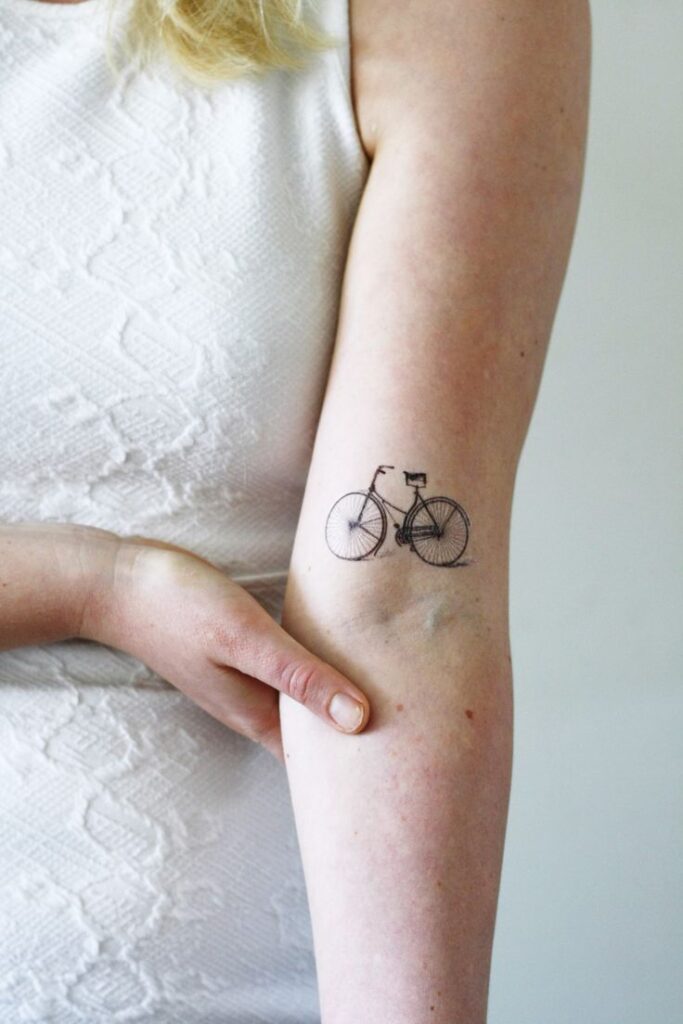 Bicycle tattoo on shoulder for women