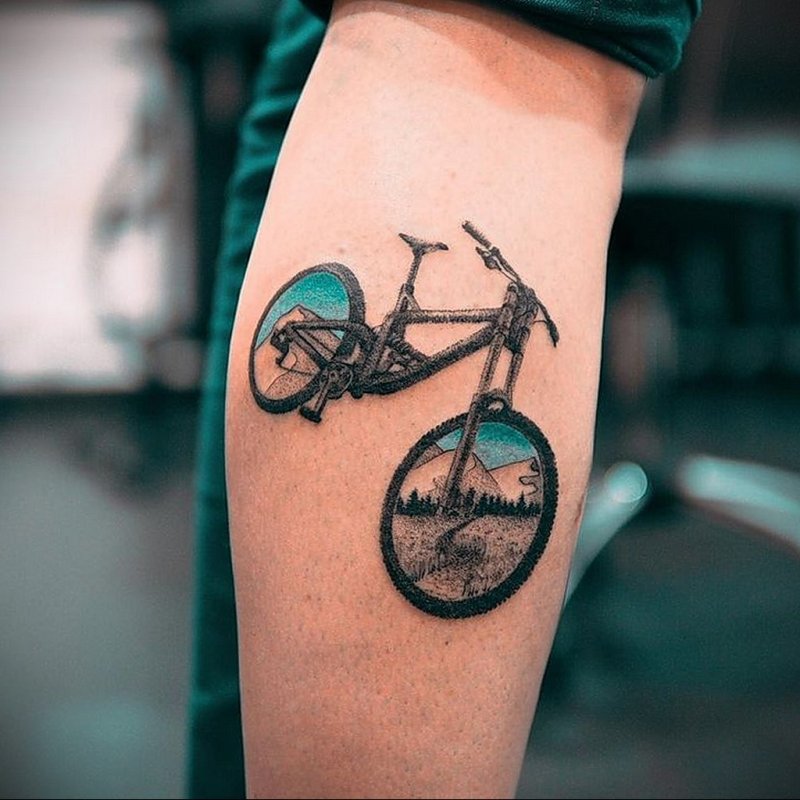 Colorful bicycle tattoo on shin for men