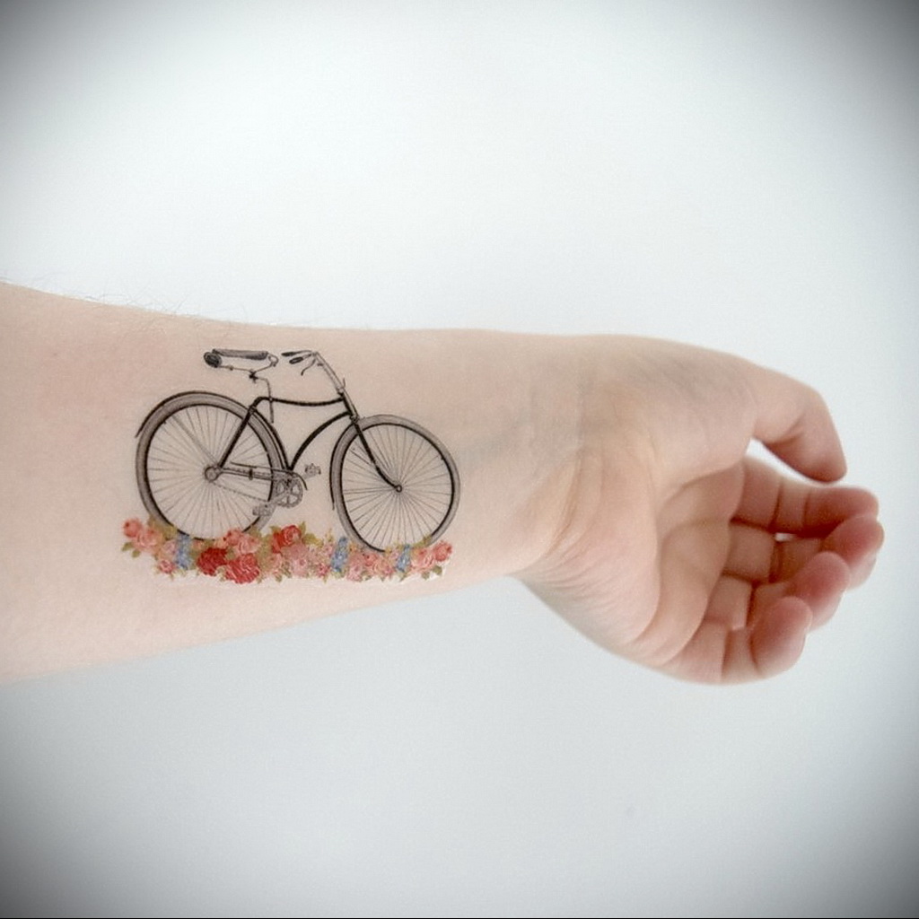 Colorful bicycle tattoo on forearm for women