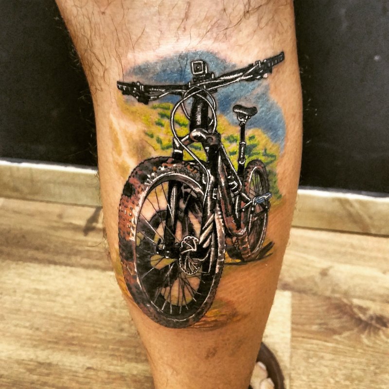 Colorful bicycle tattoo on calf for men