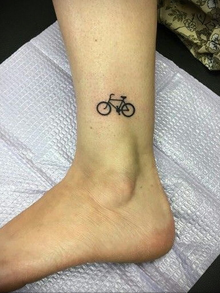 Bicycle tattoo on the shin for women