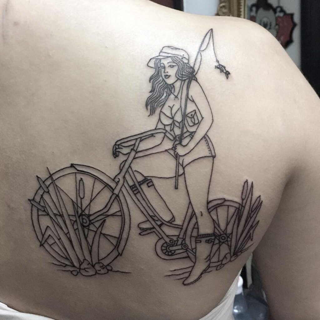 Bicycle and girl tattoo on the shoulder blade for women