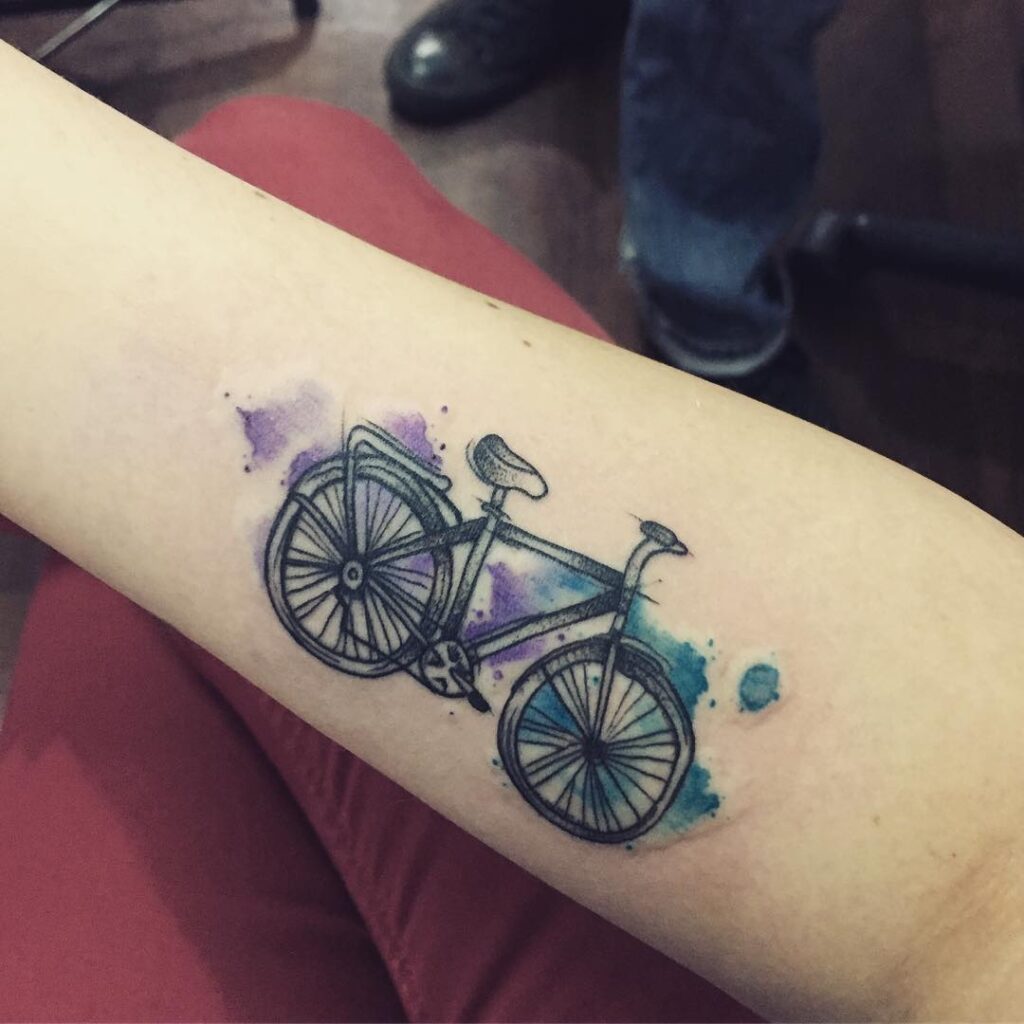 Bicycle tattoo on arm for women