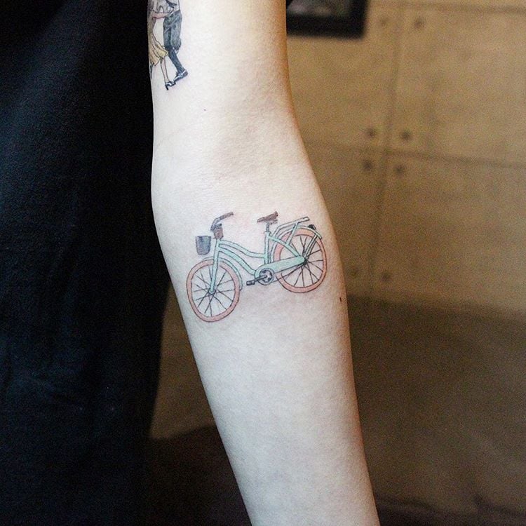 Colorful bicycle tattoo on forearm for men