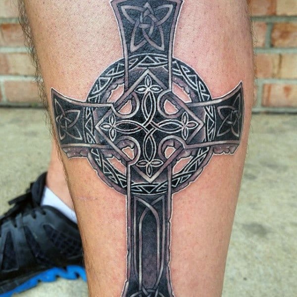 Celtic cross tattoo on shin for men