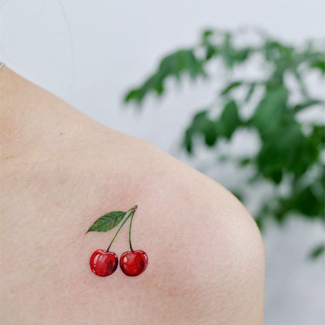 Cherry tattoo on collarbone for women