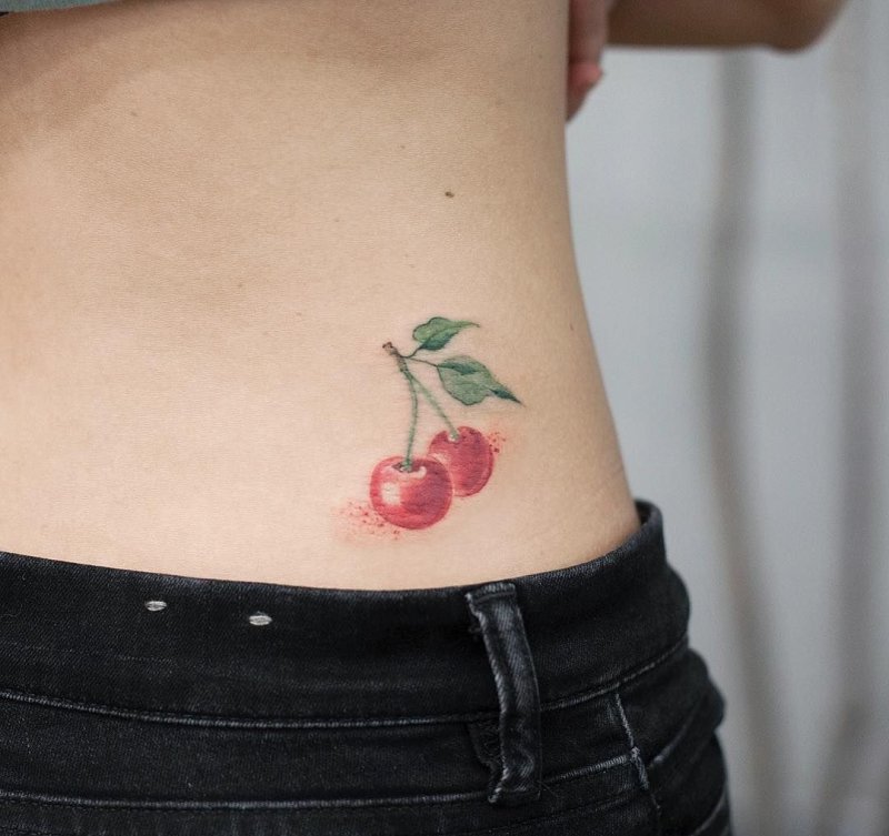 Cherry tattoo on back for women