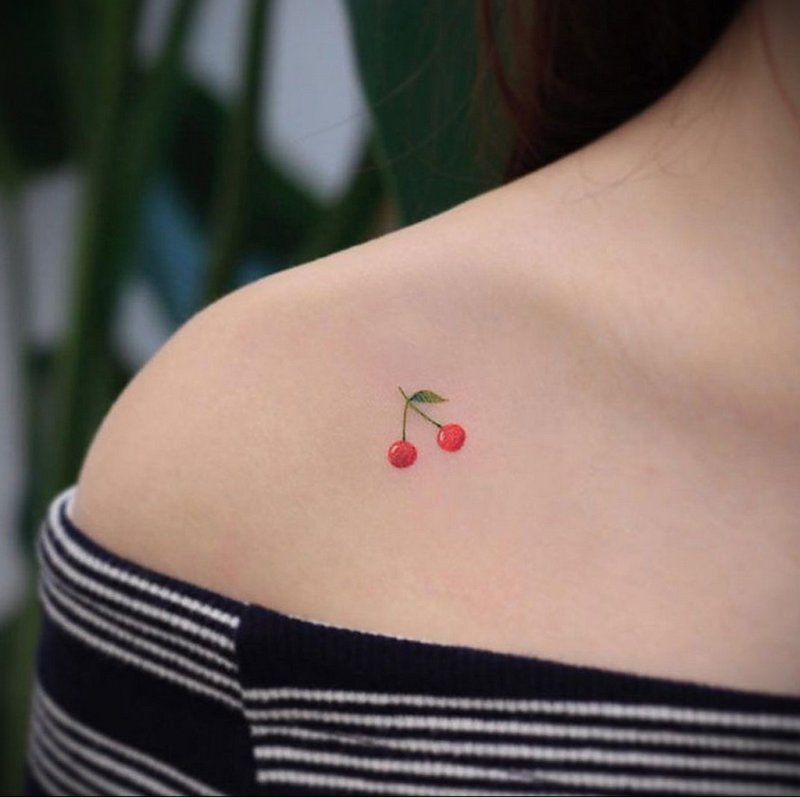 Cherry tattoo on collarbone for women