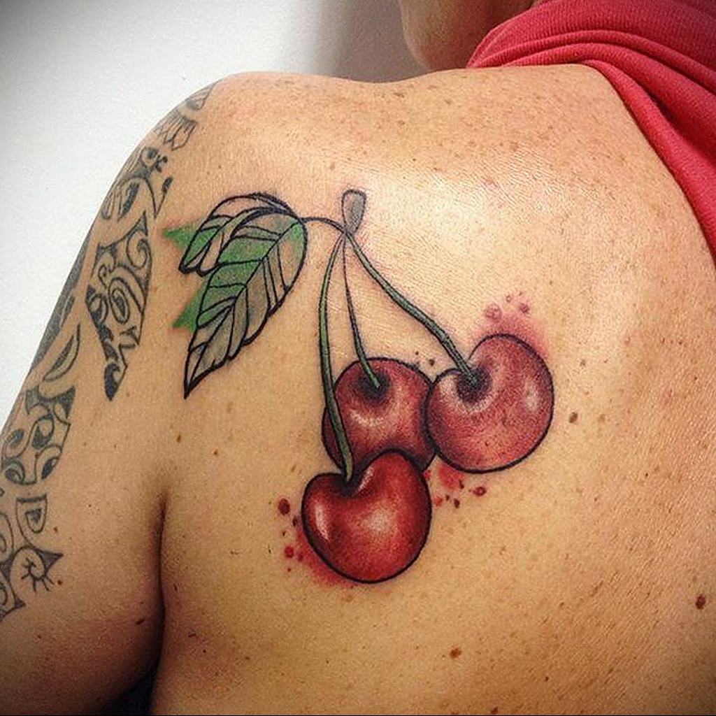 Cherry tattoo on the shoulder blade for women