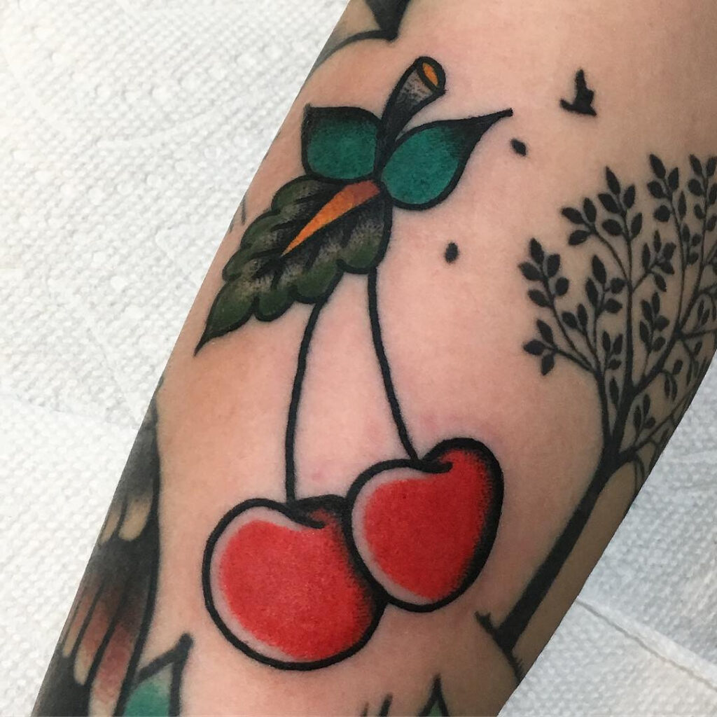 Large cherry tattoo on the arm for women