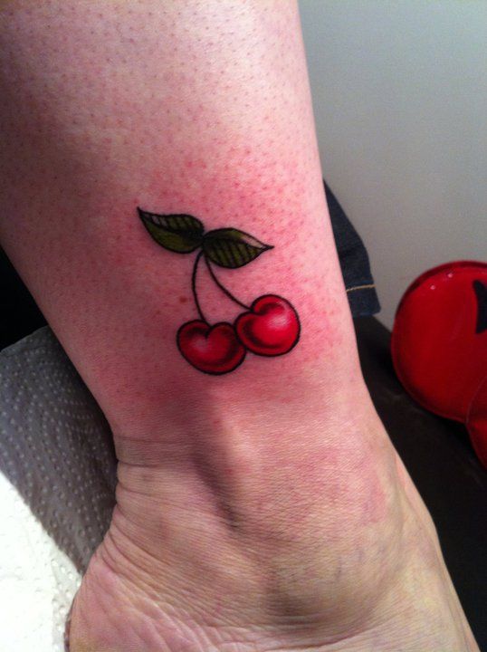 Cherry tattoo on shin for women