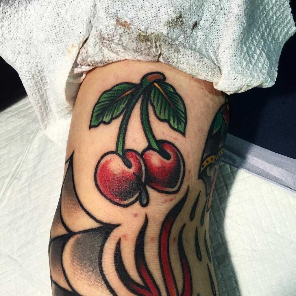 Cherry tattoo on the arm for men