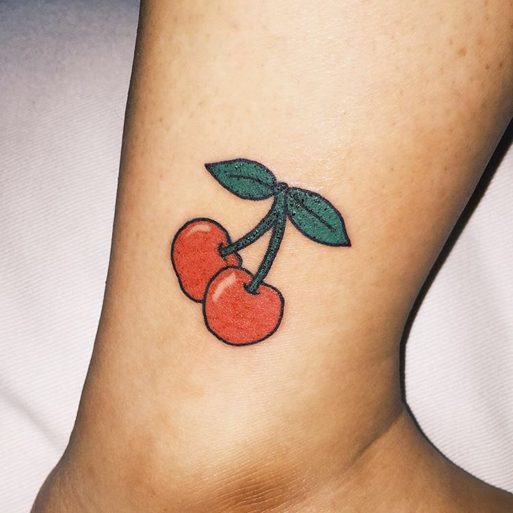 Cherry tattoo on shin for women