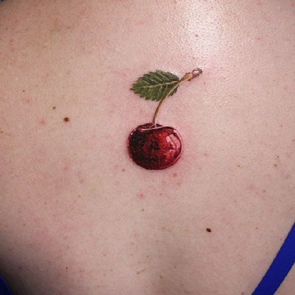 Cherry tattoo on back for women