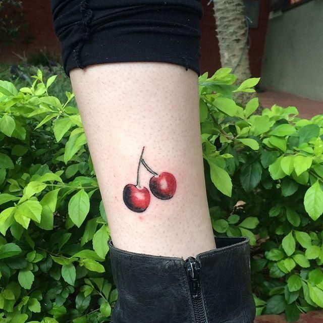 Cherry tattoo on shin for women