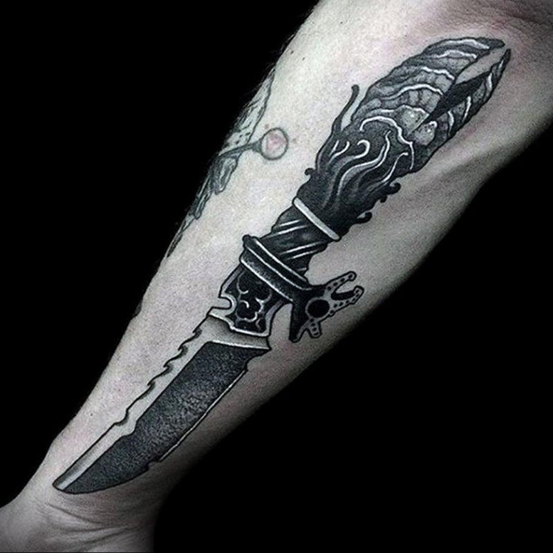 Dagger tattoo on forearm for men