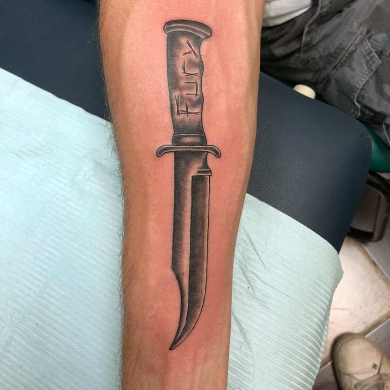 Dagger tattoo on forearm for men