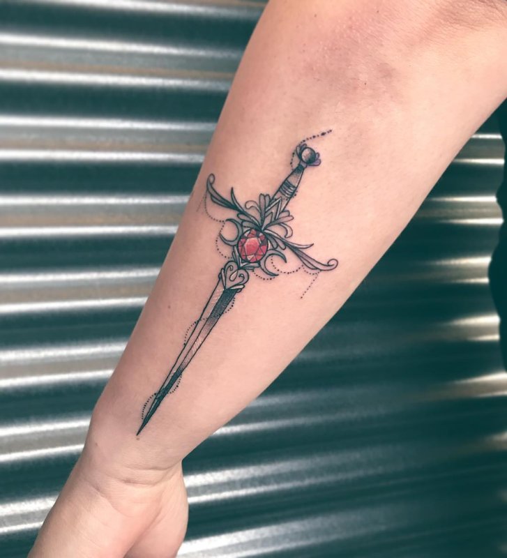 Dagger tattoo on forearm for women