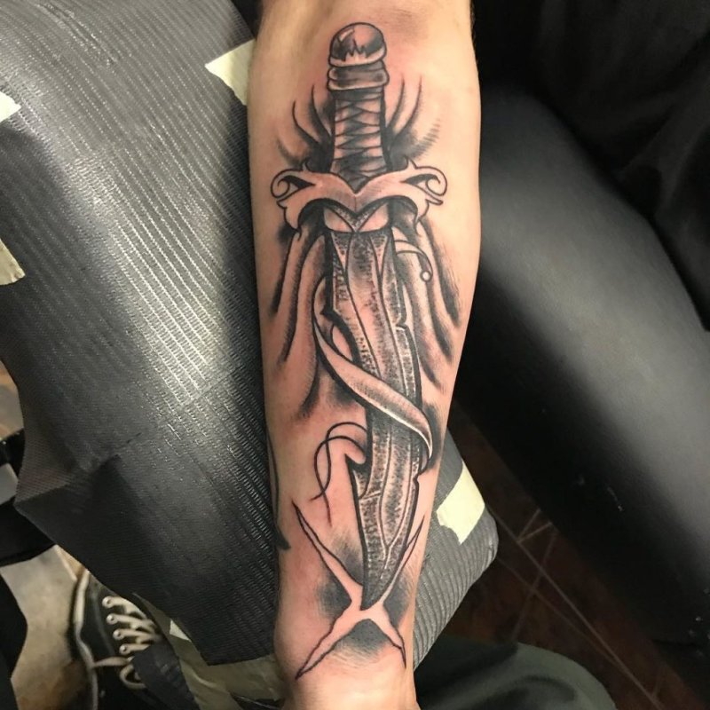 Dagger tattoo on arm for men