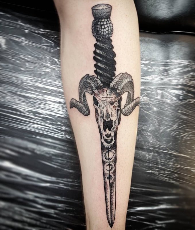 Dagger tattoo on forearm for men