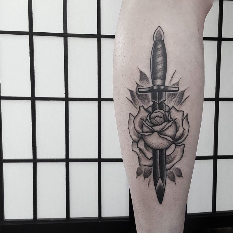 Dagger tattoo on calf for men