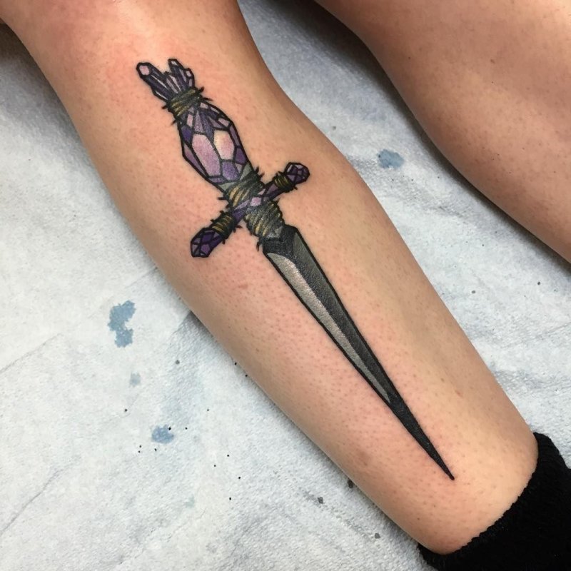 Dagger tattoo on leg for women