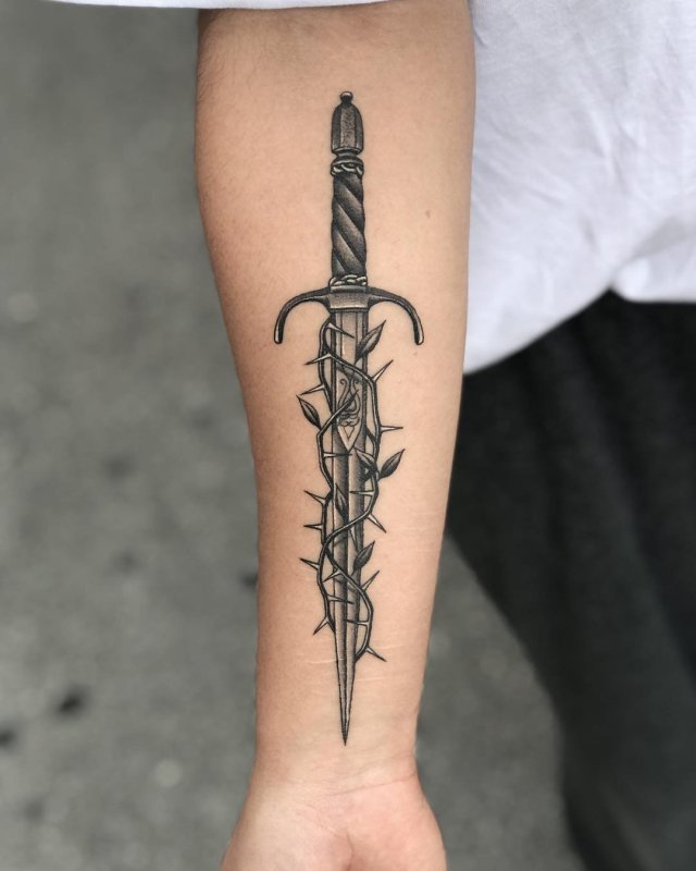 Dagger tattoo on forearm for women