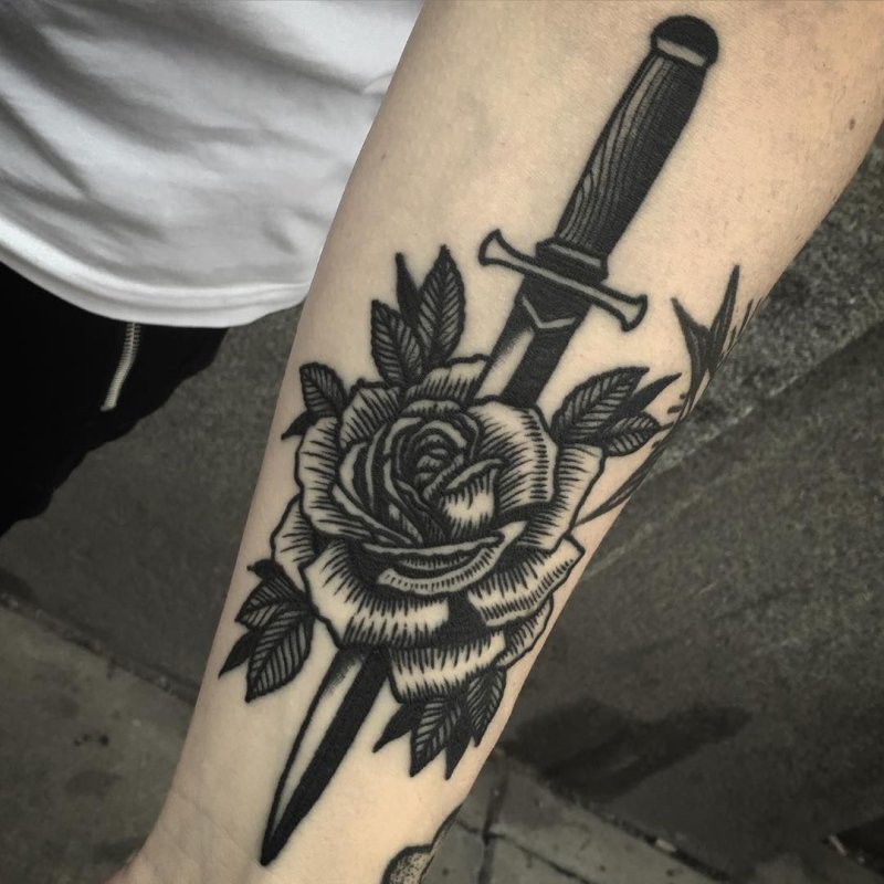 Dagger and rose tattoo on the arm for men