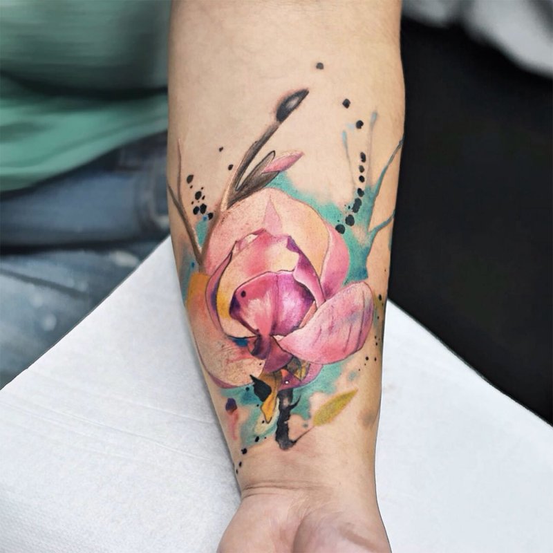 Watercolor style tattoo on forearm for women