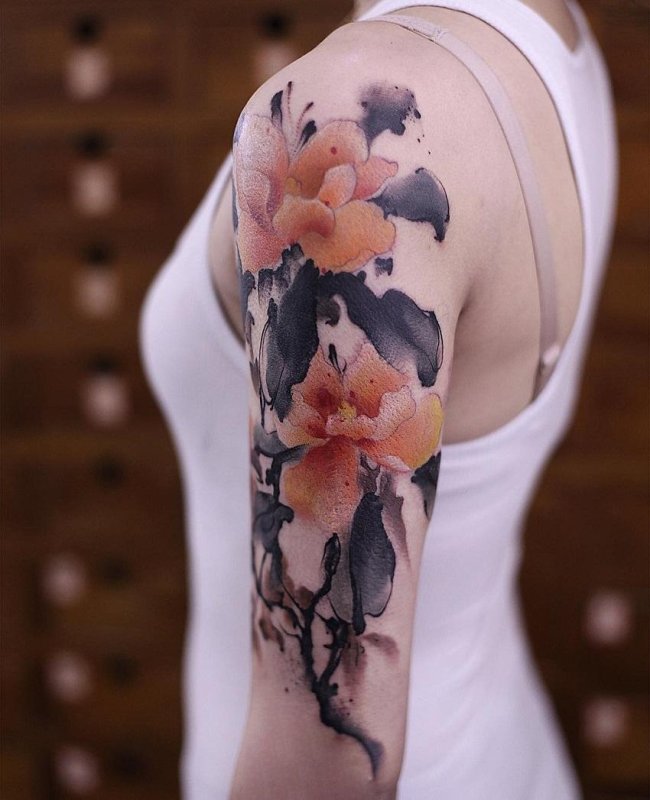 Watercolor style tattoo on the shoulder for women