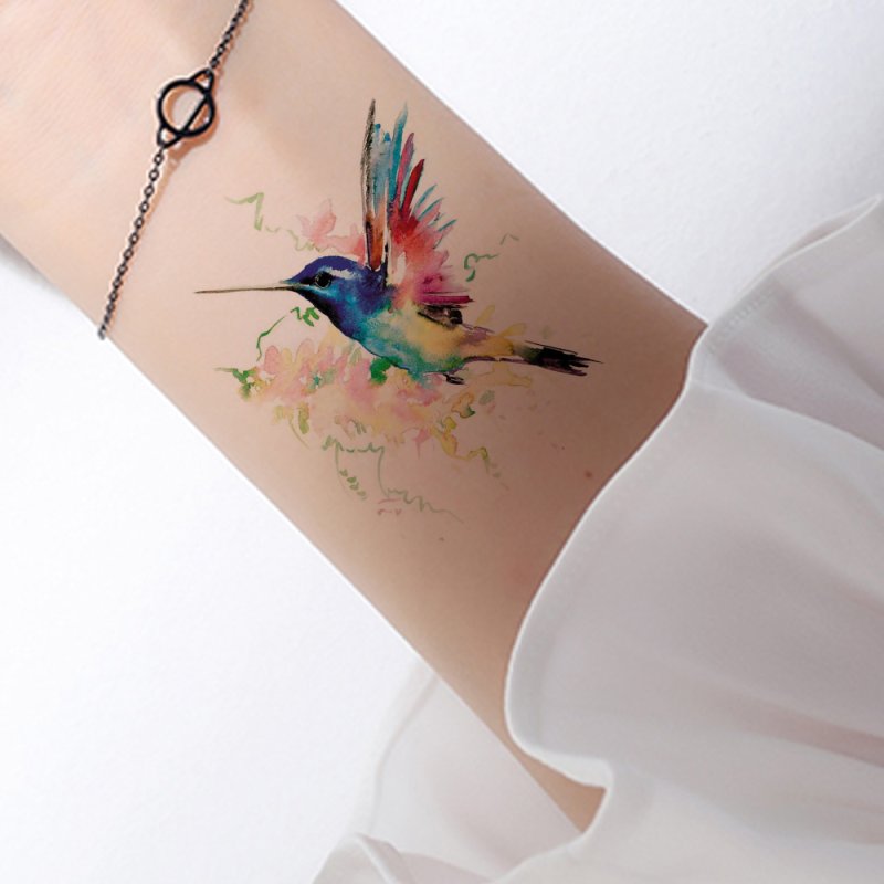 Watercolor style hummingbird tattoo on the arm for women