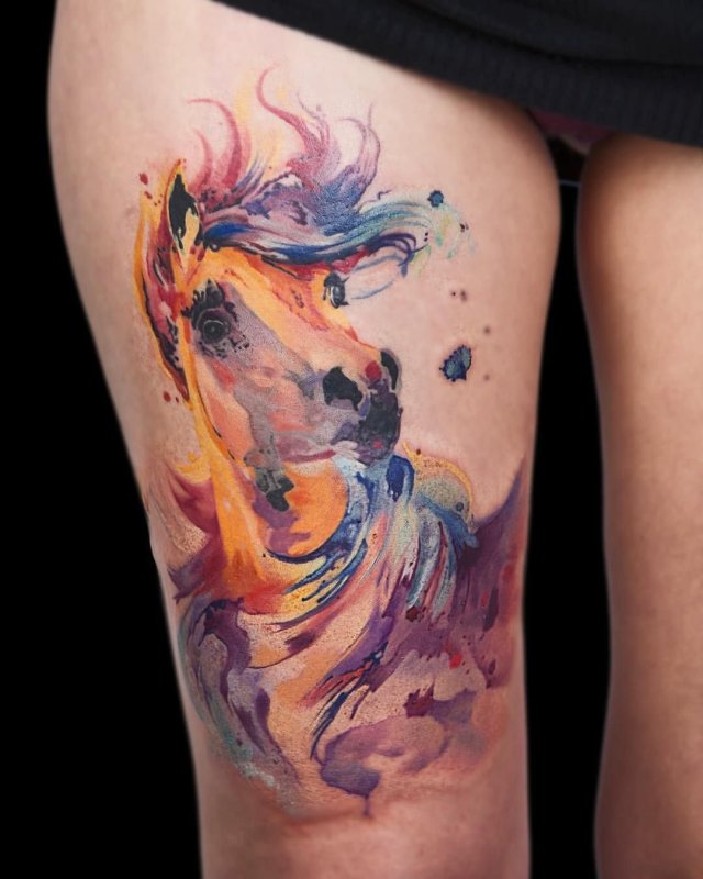 Watercolor style tattoo on the thigh for women