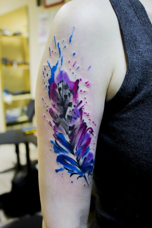 Watercolor style tattoo on the shoulder for men