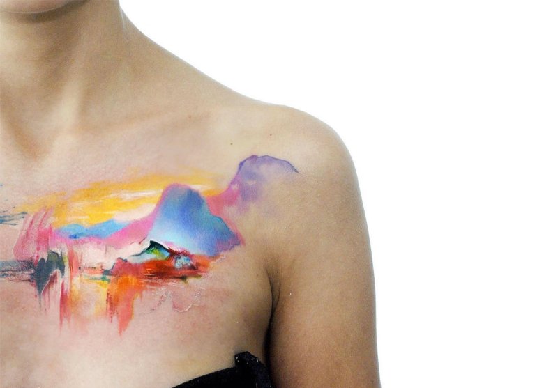 Watercolor style tattoo on the collarbone for women