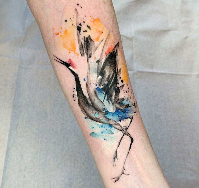 Watercolor style tattoo on forearm for women