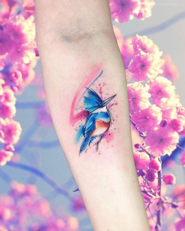 Watercolor style tattoo on forearm for women