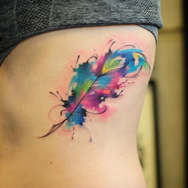 Watercolor style feather tattoo on the side for women