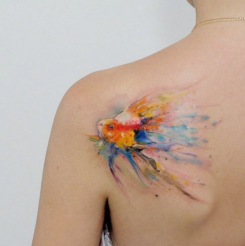 Watercolor style tattoo on the shoulder blade for women