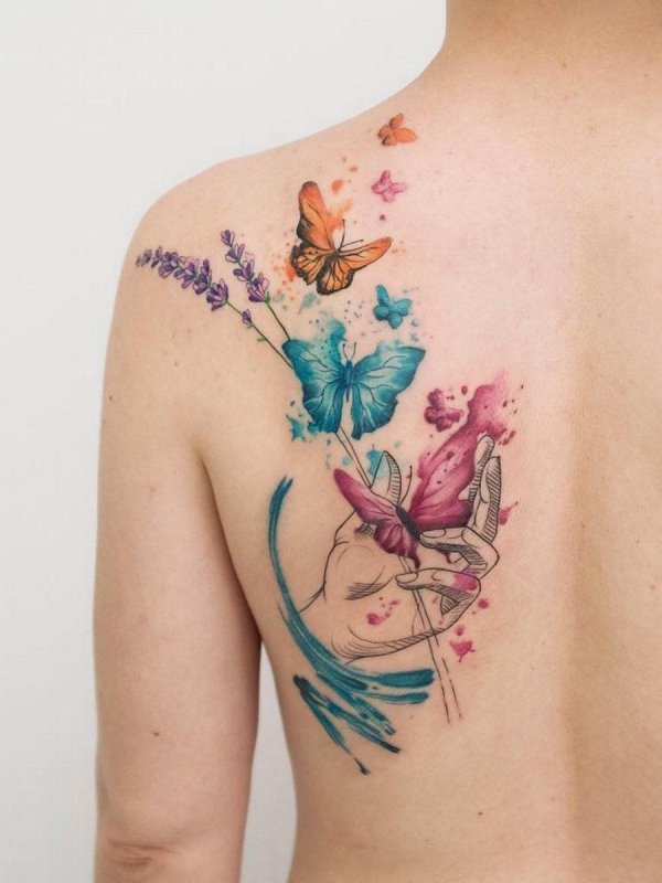 Watercolor style tattoo on the shoulder blade for women