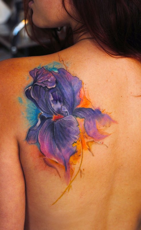 Watercolor style tattoo on the shoulder blade for women