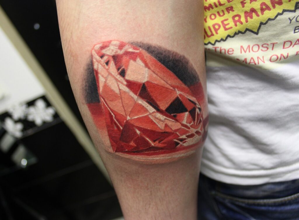 Colored diamond tattoo on arm for men