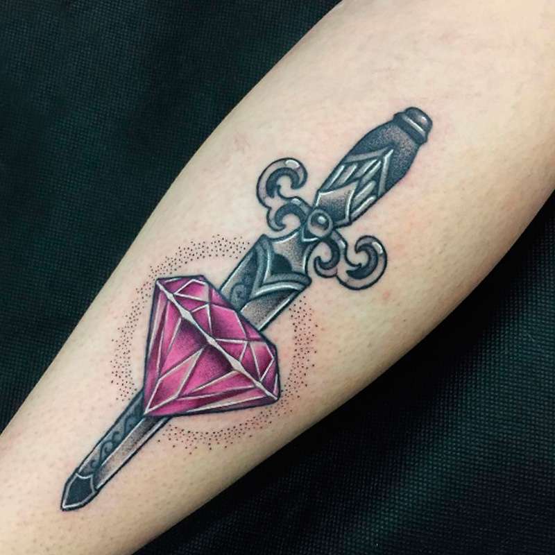 Diamond and dagger tattoo on lower leg for women