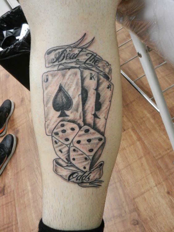 Dice tattoo on shin for women