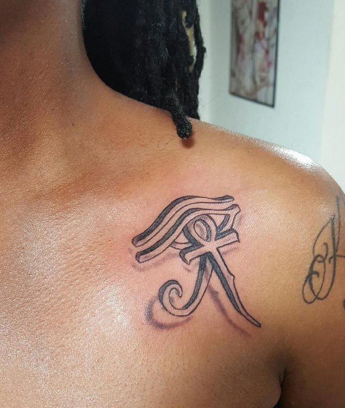 Ankh tattoo on collarbone for women