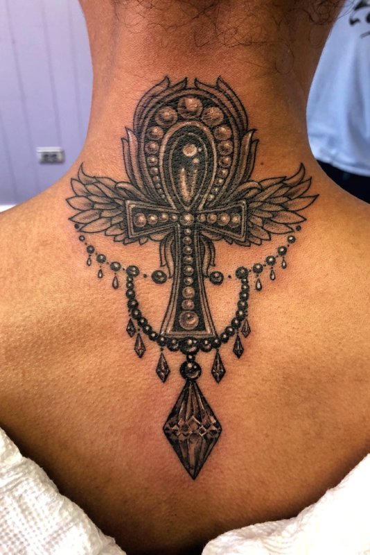 Ankh tattoo on the back of the head for women