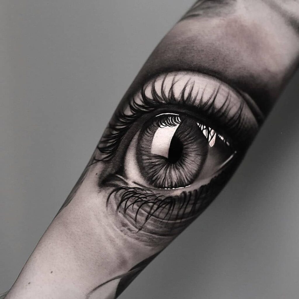 Eye tattoo on arm for women