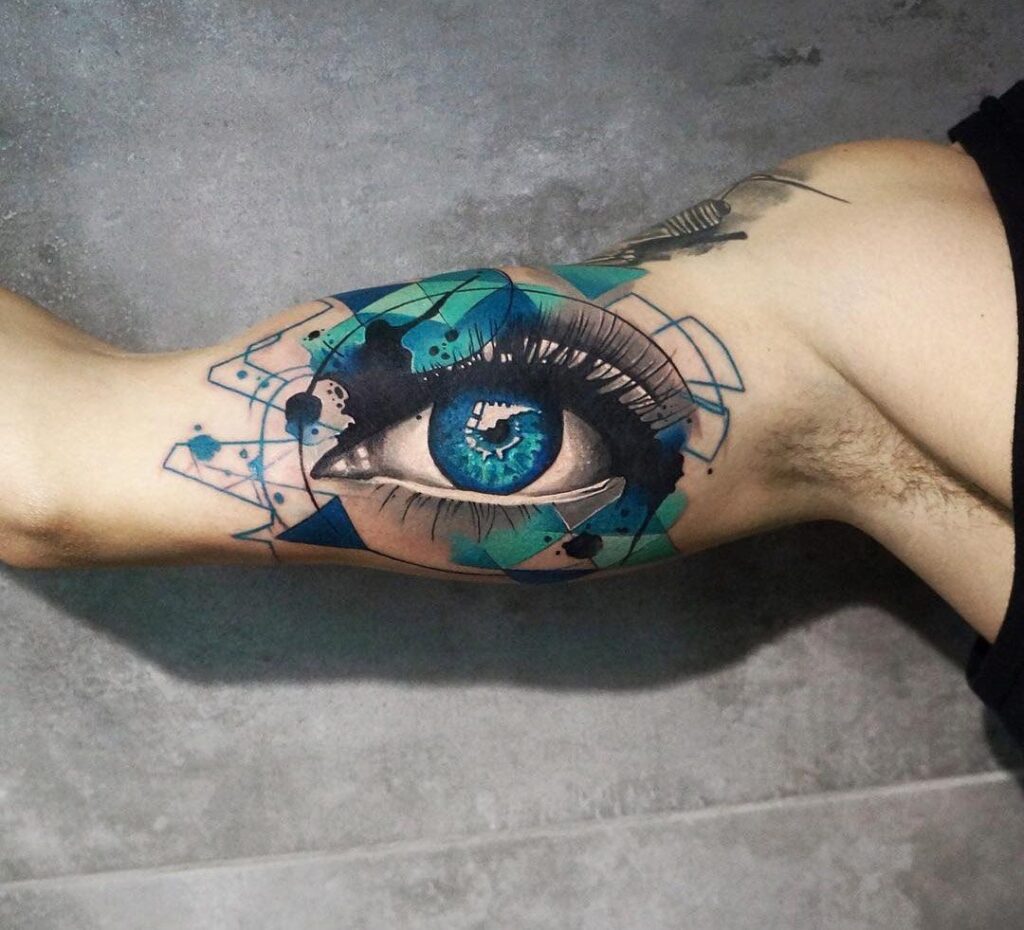 Colorful eye tattoo on arm for men