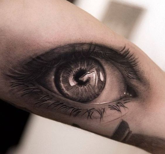 Large eye tattoo on the arm for men